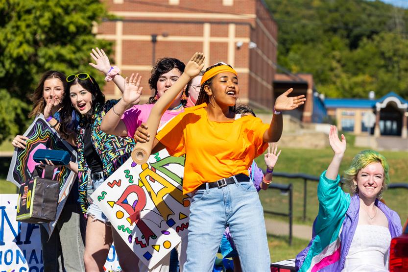 Students cheer for a homecoming parade